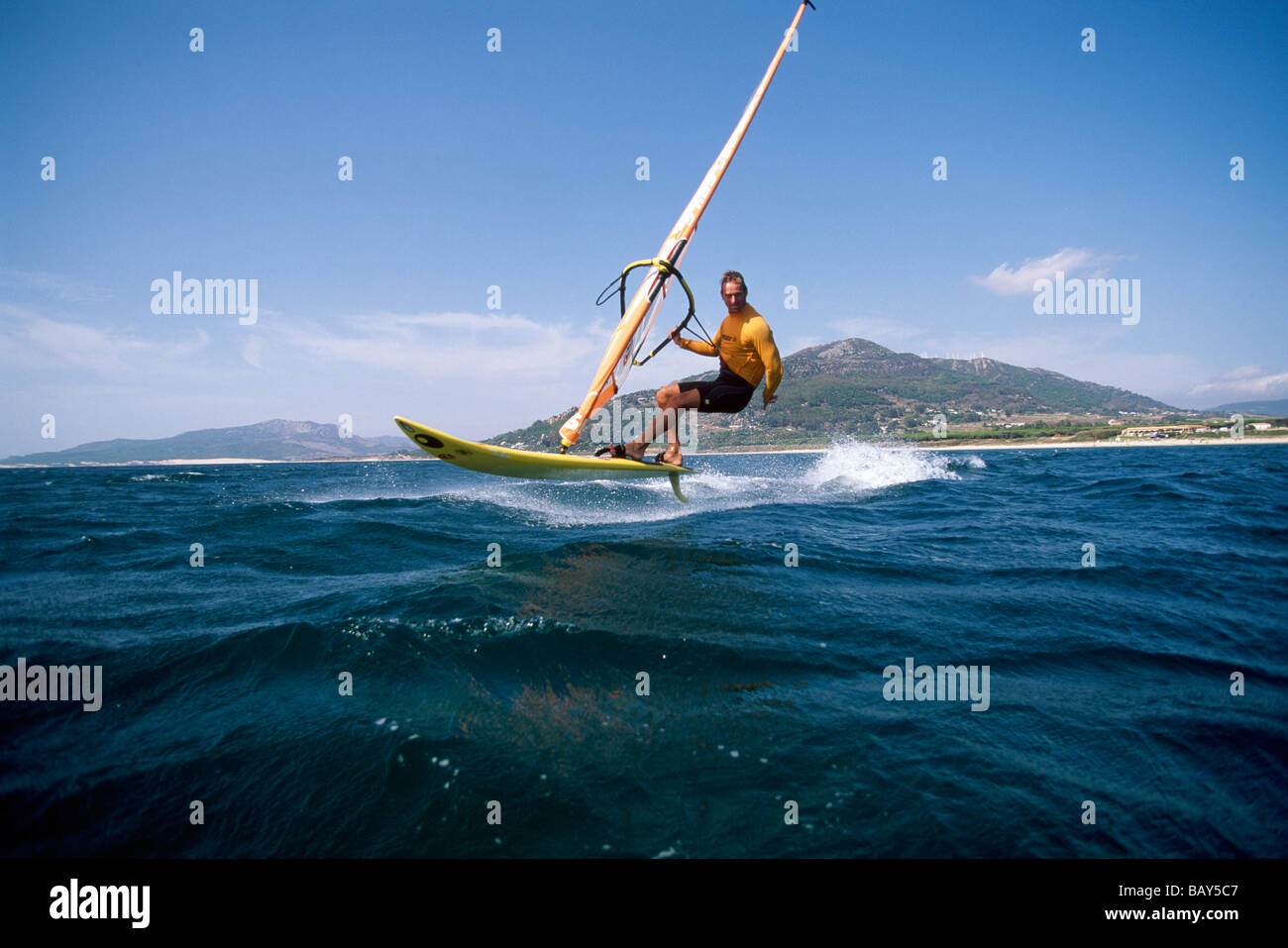 Windsurfer surfing over the sea, Playa Los Lances, Tarifa, Costa de la Luz, Andalusia, Spain Stock Photo