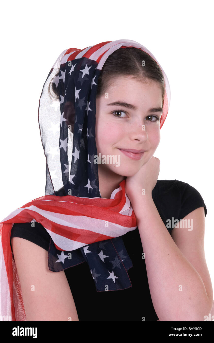 A young girl poses innocently with an American scarf covering her head Stock Photo