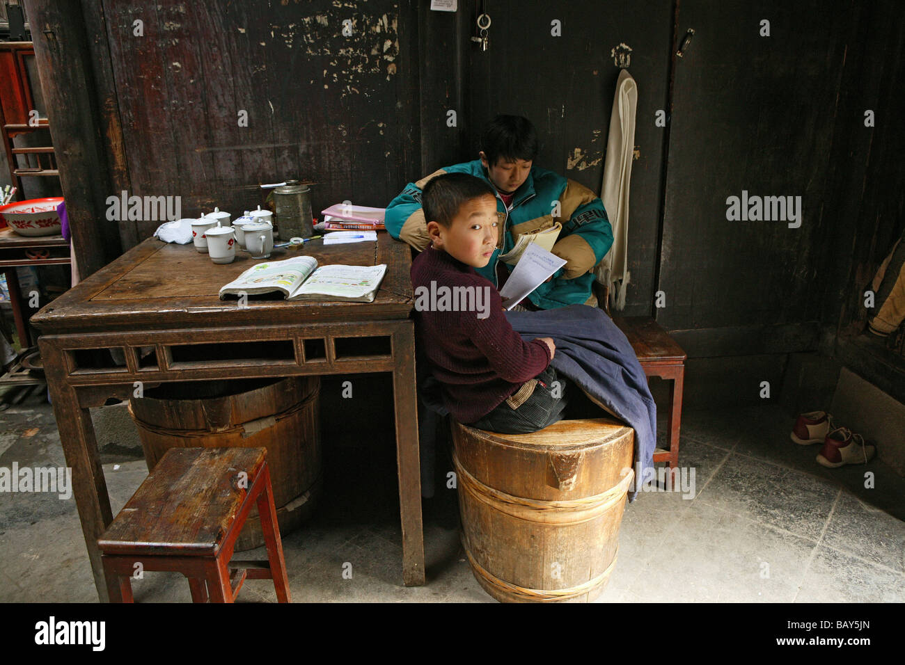 Two boys doing homework in a residential house at the village Hongcun, Huangshan, China, Asia Stock Photo