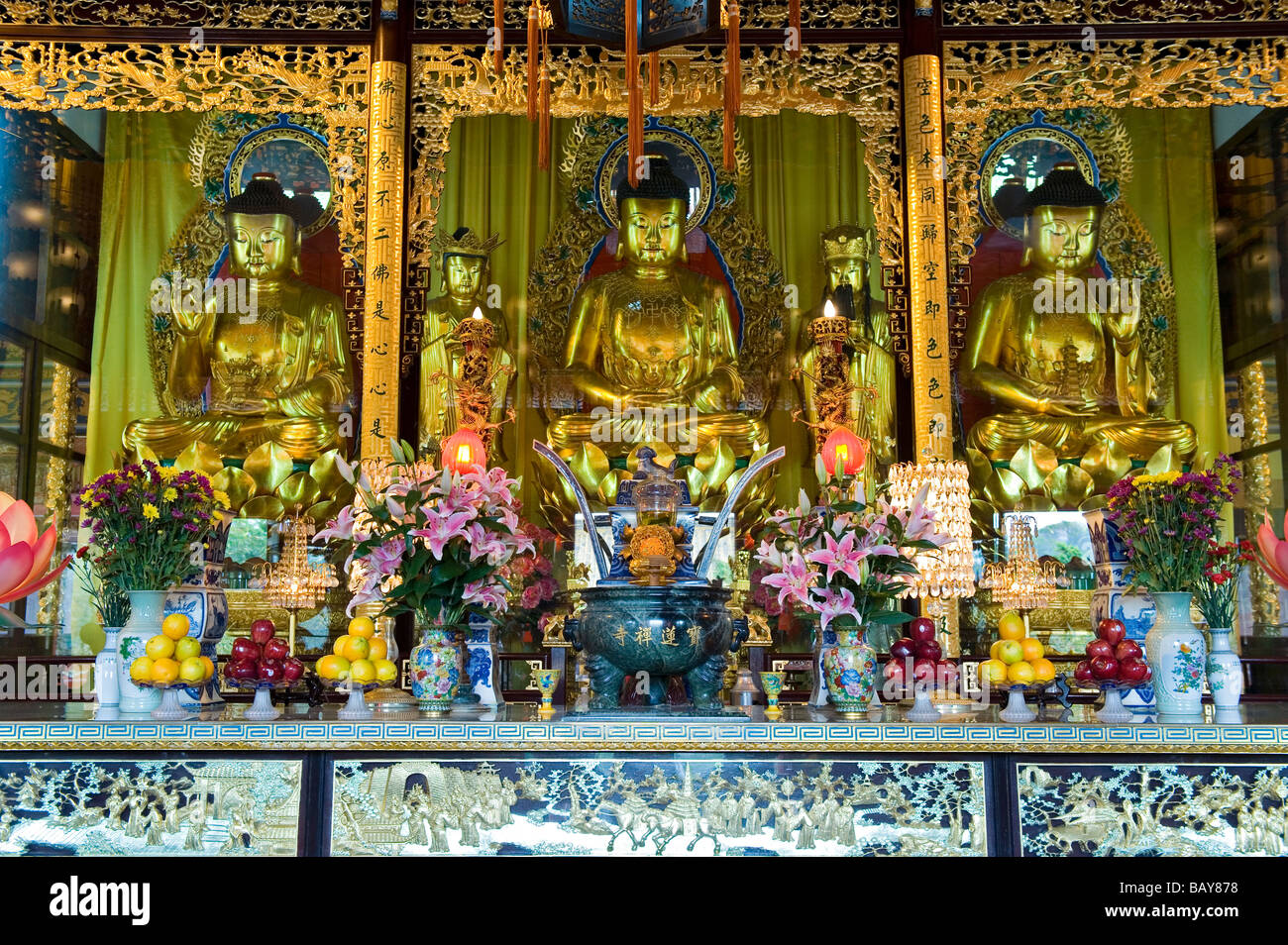 Gilded Buddha's on the Main Altar inside the Hall of the Great Hero at Po Lin Monastery. Lantau Island, Hong Kong Stock Photo