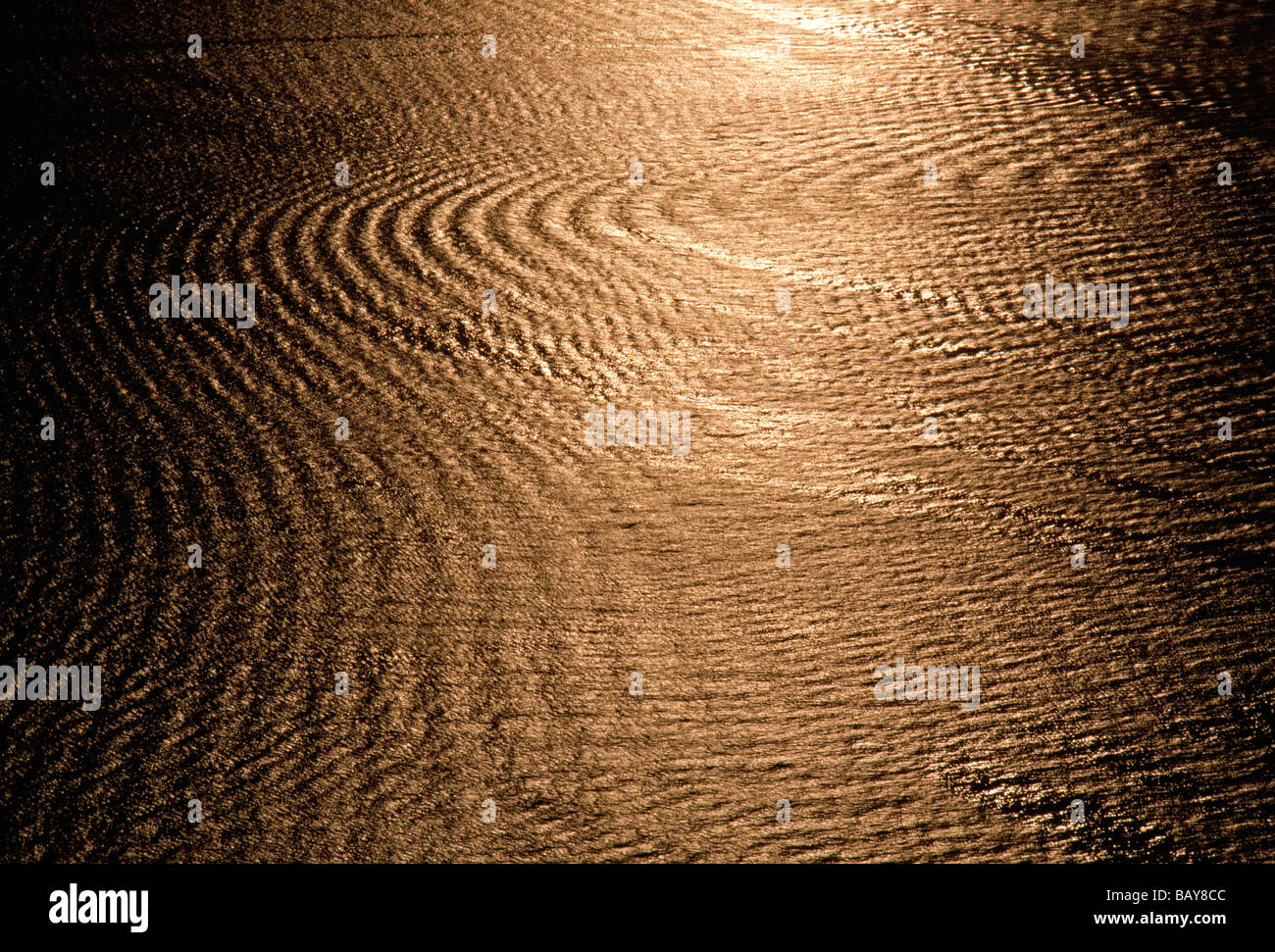 Golden sunset reflects in the ripples and waves in New York Harbor New York USA Stock Photo