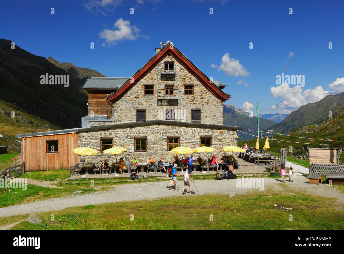 hikers on terrace of hut Franz-Senn-Huette, Stubaier Alpen range, Stubai, Tyrol, Austria Stock Photo