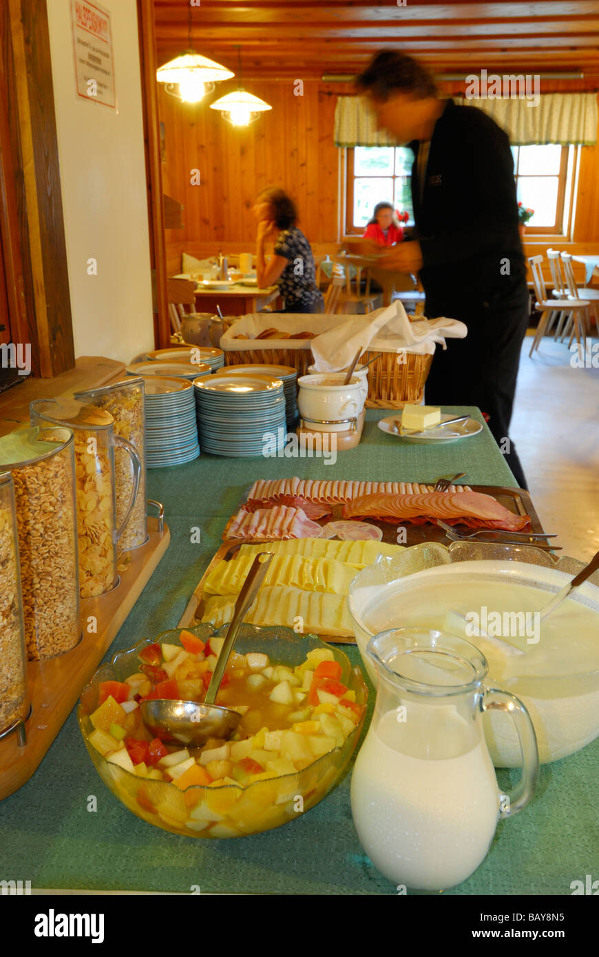 breakfast buffet with cereal and cold cuts, guests at tables out of focus in background, hut Franz-Senn-Huette, Stubaier Alpen r Stock Photo