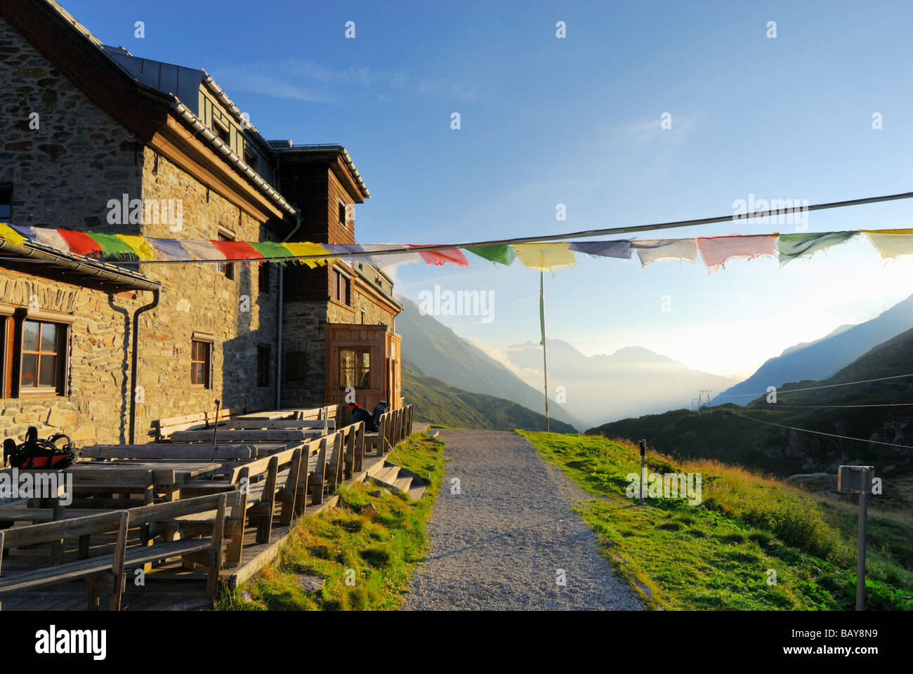 hut Franz-Senn-Huette with prayer flags, Stubaier Alpen range, Stubai, Tyrol, Austria Stock Photo
