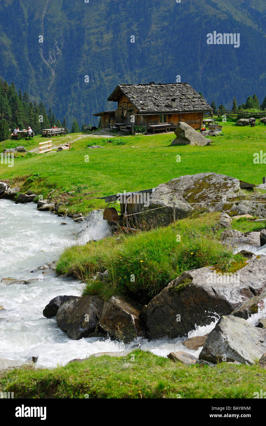 alpine hut Ochsenalm with stream, hut Falbesoner Alm, Stubaier Alpen range, Stubai, Tyrol, Austria Stock Photo
