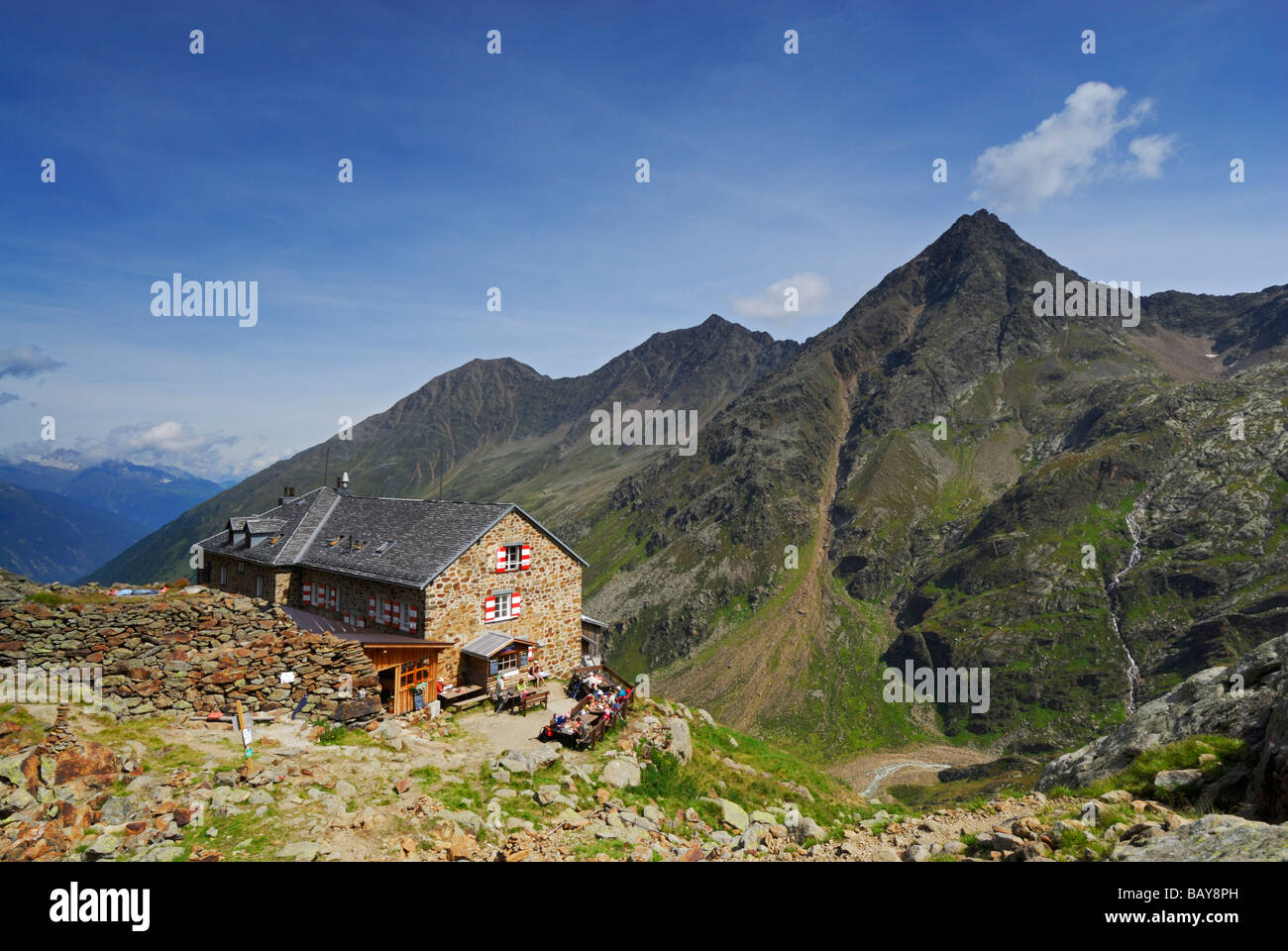 hikers in front of hut Nuernberger Huette, Stubaier Alpen range, Stubai, Tyrol, Austria Stock Photo