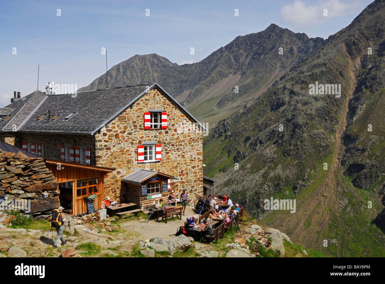 hiker reaching hut Nuernberger Huette, Stubaier Alpen range, Stubai, Tyrol, Austria Stock Photo