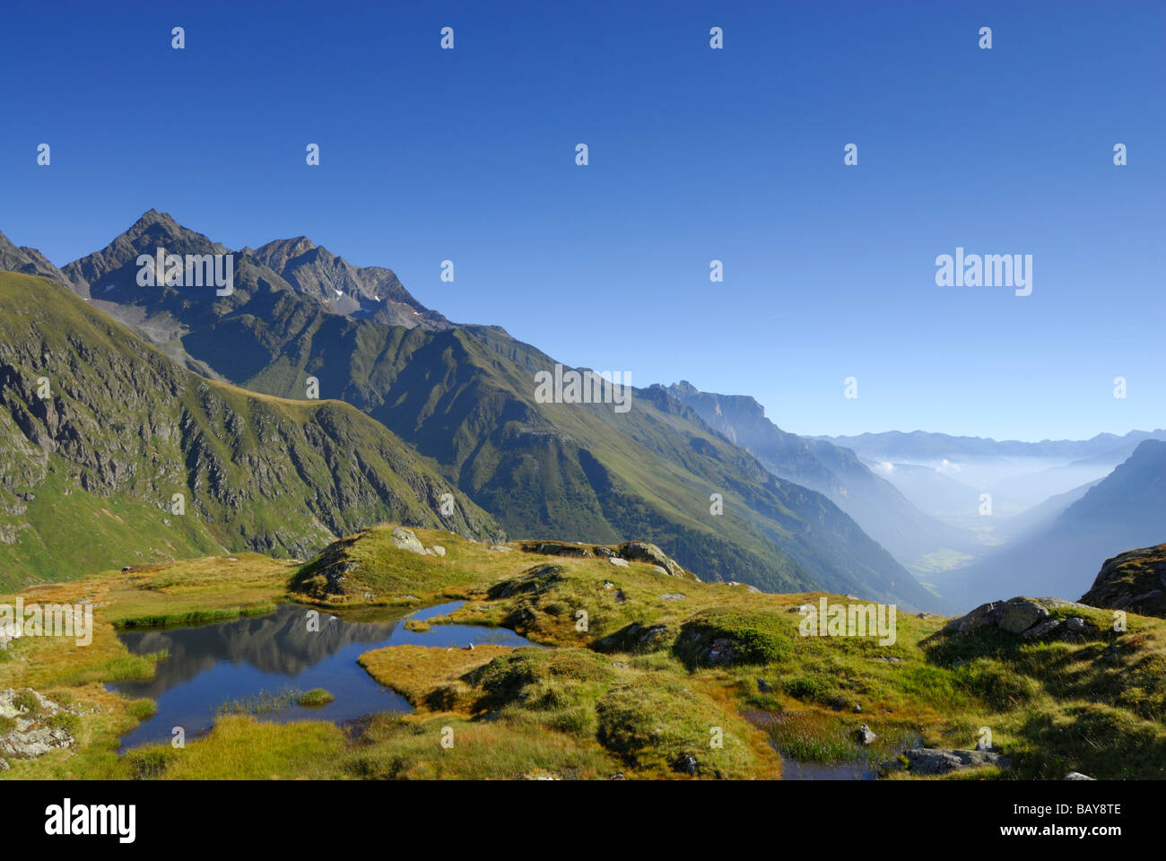 little lake with Habicht in background, fog bank in valley Gschnitztal, Stubaier Alpen range, Stubai, Tyrol, Austria Stock Photo