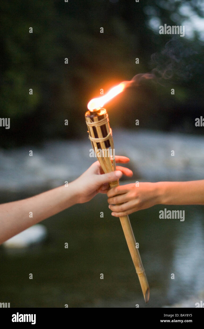 Hands holding torch Stock Photo Alamy