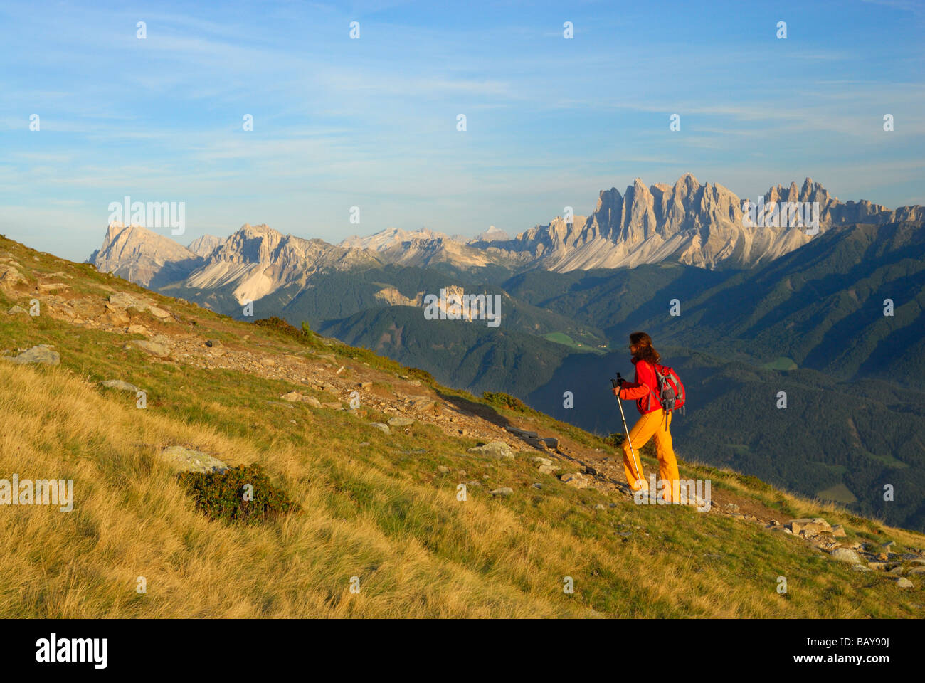 young woman on trail with view to Dolomites with Peitlerkofel and Geislergruppe range, Radlseehuette, Sarntaler Alpen, Sarntal r Stock Photo
