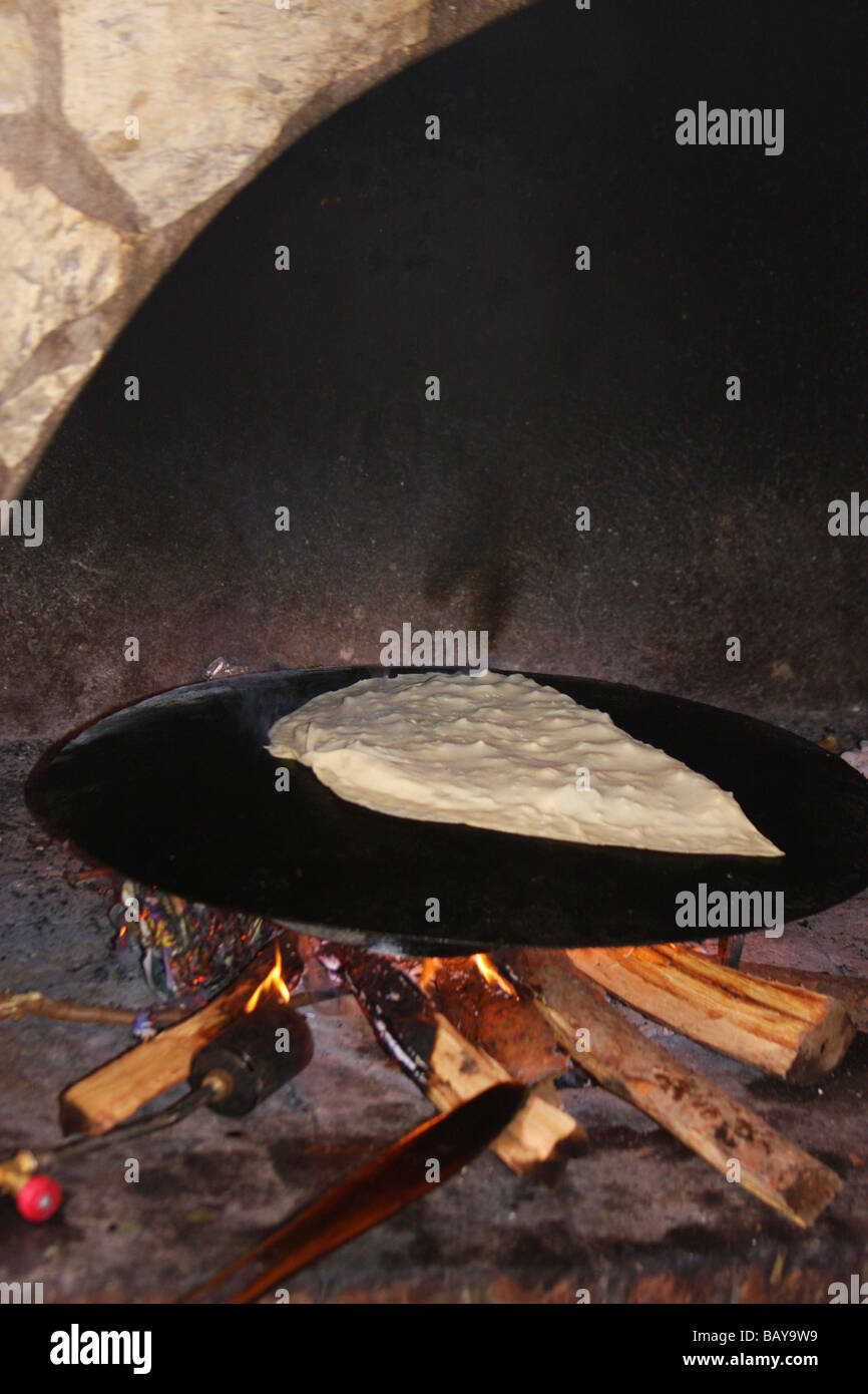 Village of Kaya Koy, Turkey - Image of a local speciality 'Village Pancake' baking in a stone oven Stock Photo