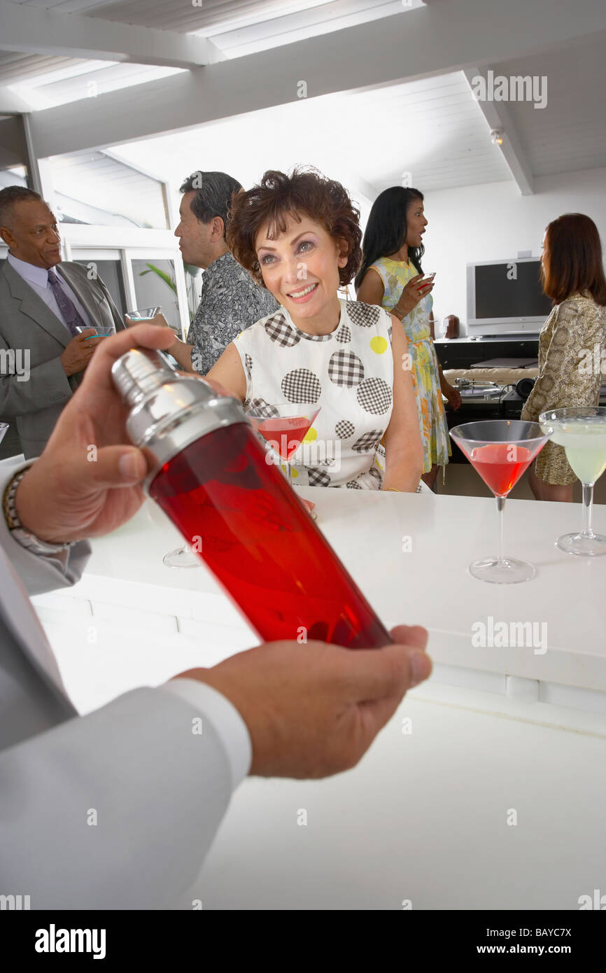 Host mixing martini cocktails at party Stock Photo Alamy