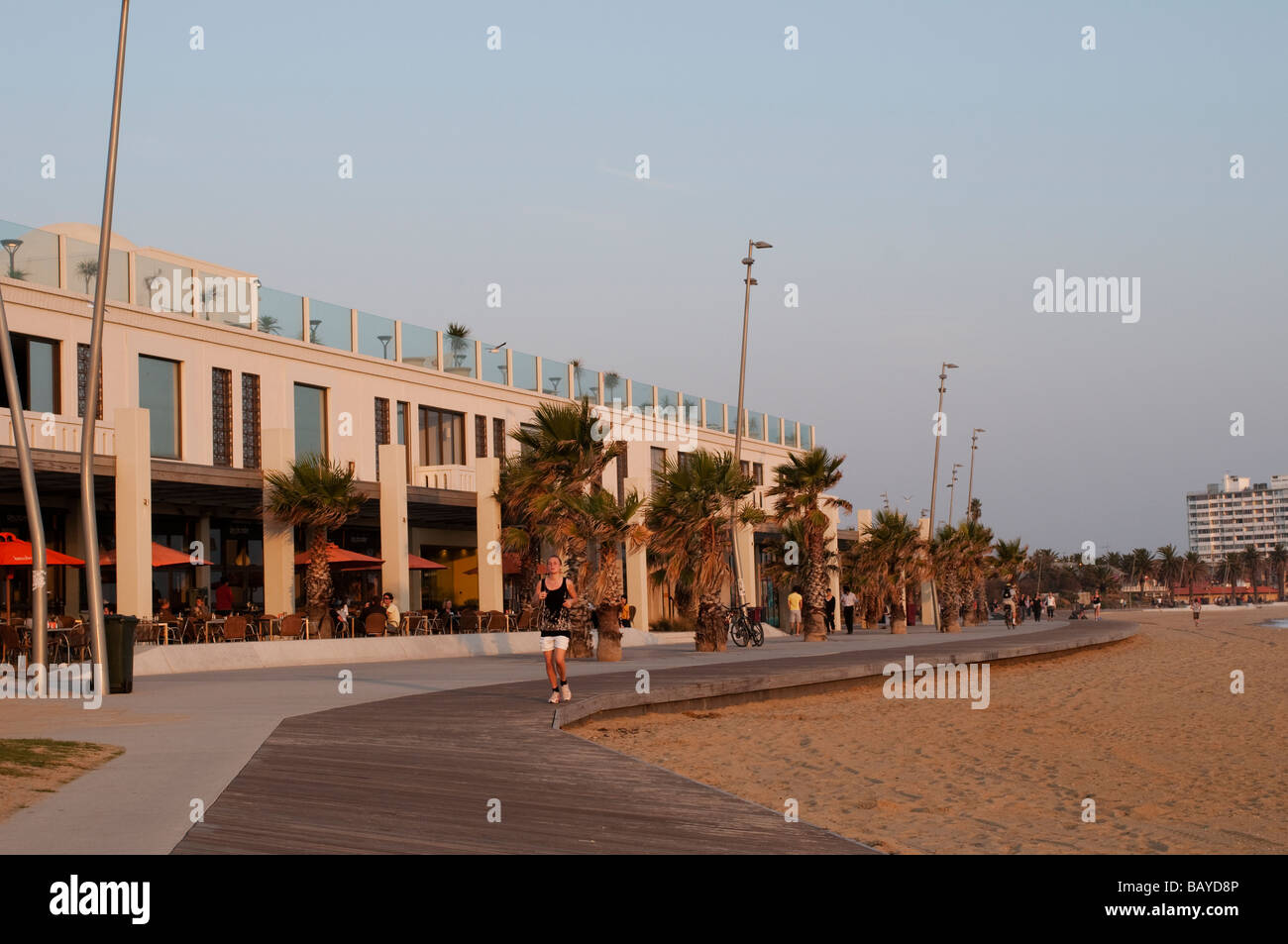 Cafe and jogger on St Kilda beachfront promenade Melbourne Victoria