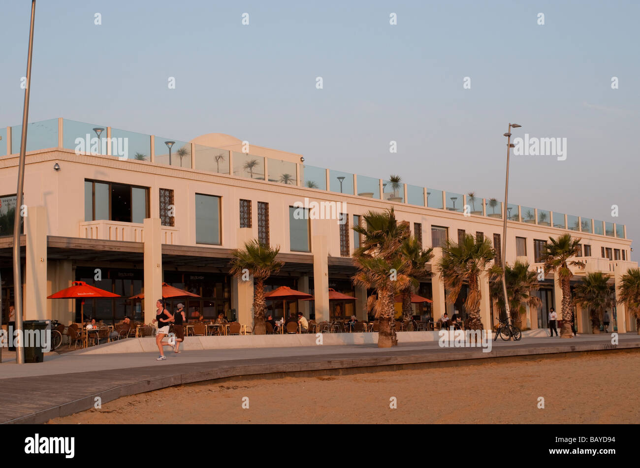 Cafe and joggers on St Kilda beachfront promenade Melbourne Victoria