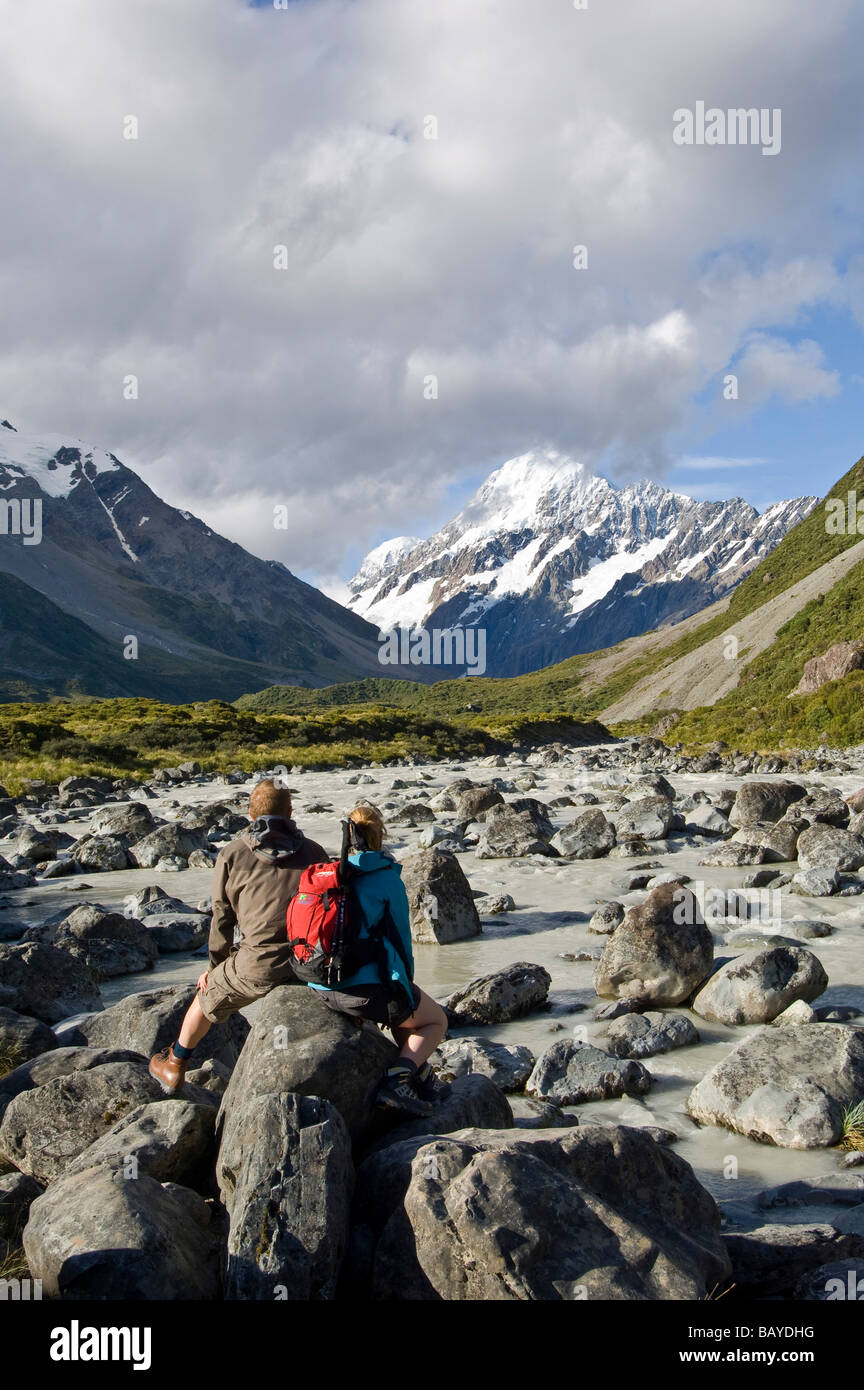 Couple admiring view of Mount Cook Hooker Valley trail Mt Cook Aoraki National Park South Island New Zealand Stock Photo