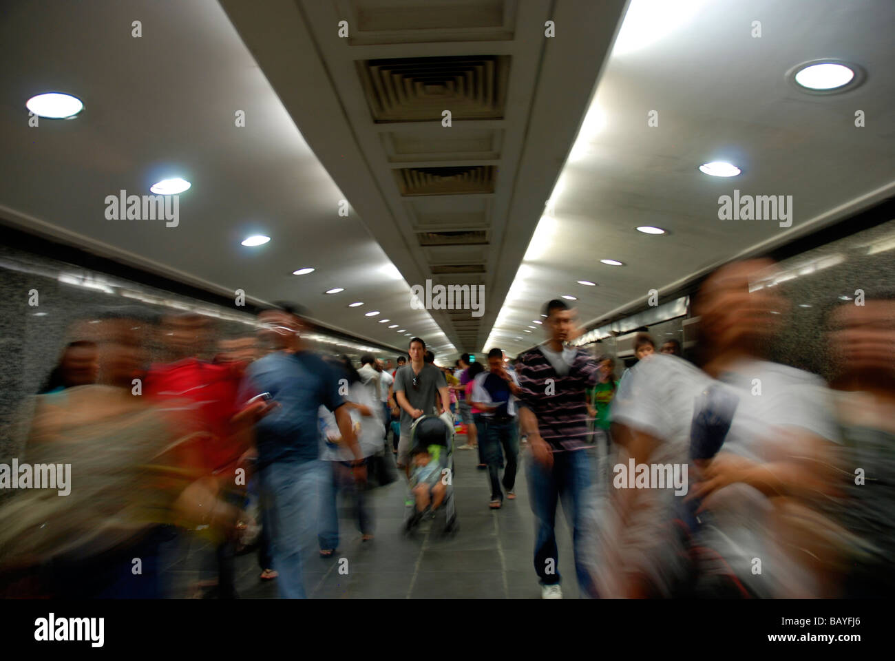 People walking in underground passage in Singapore Stock Photo