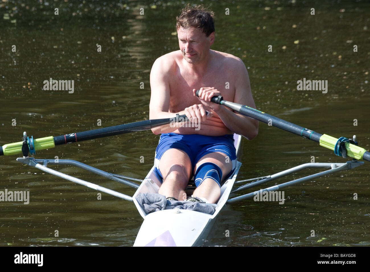 row rowing scull oars canoeist middle aged man Stock Photo Alamy