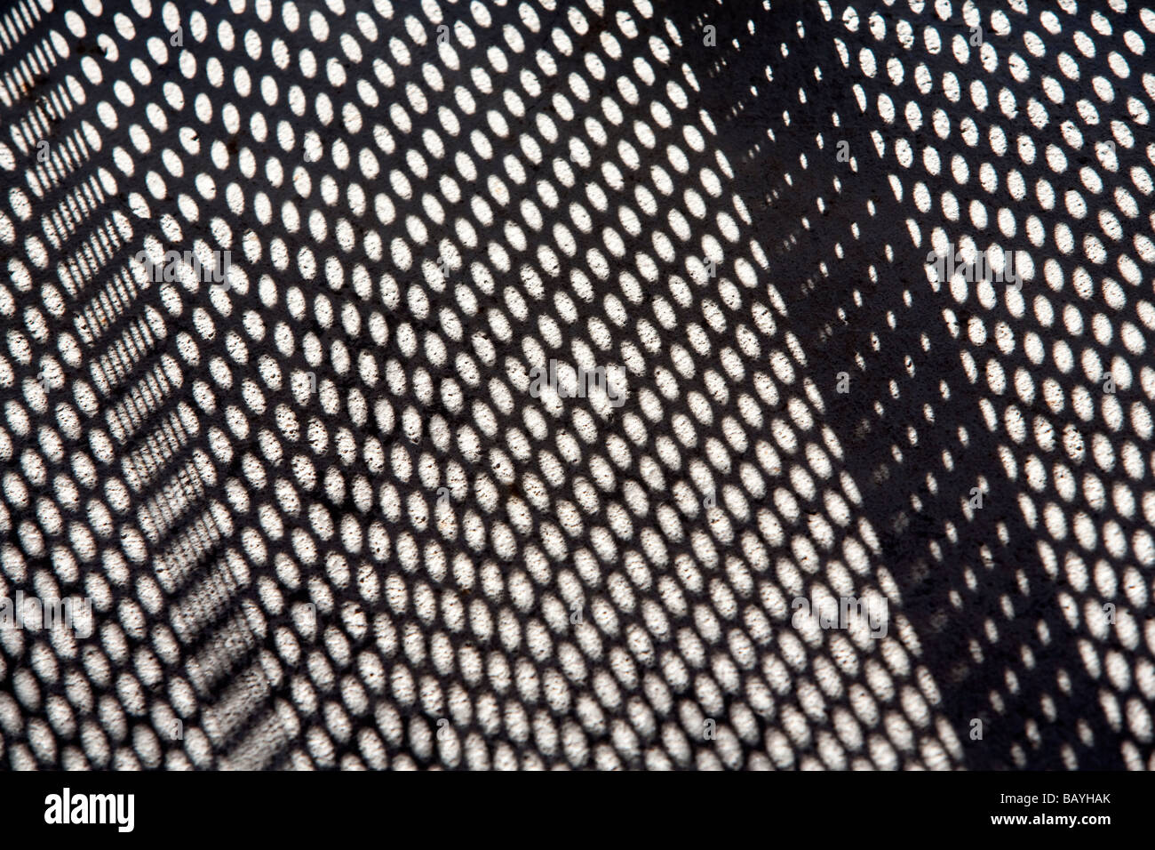 Perforated mesh shadow on concrete floor Stock Photo - Alamy
