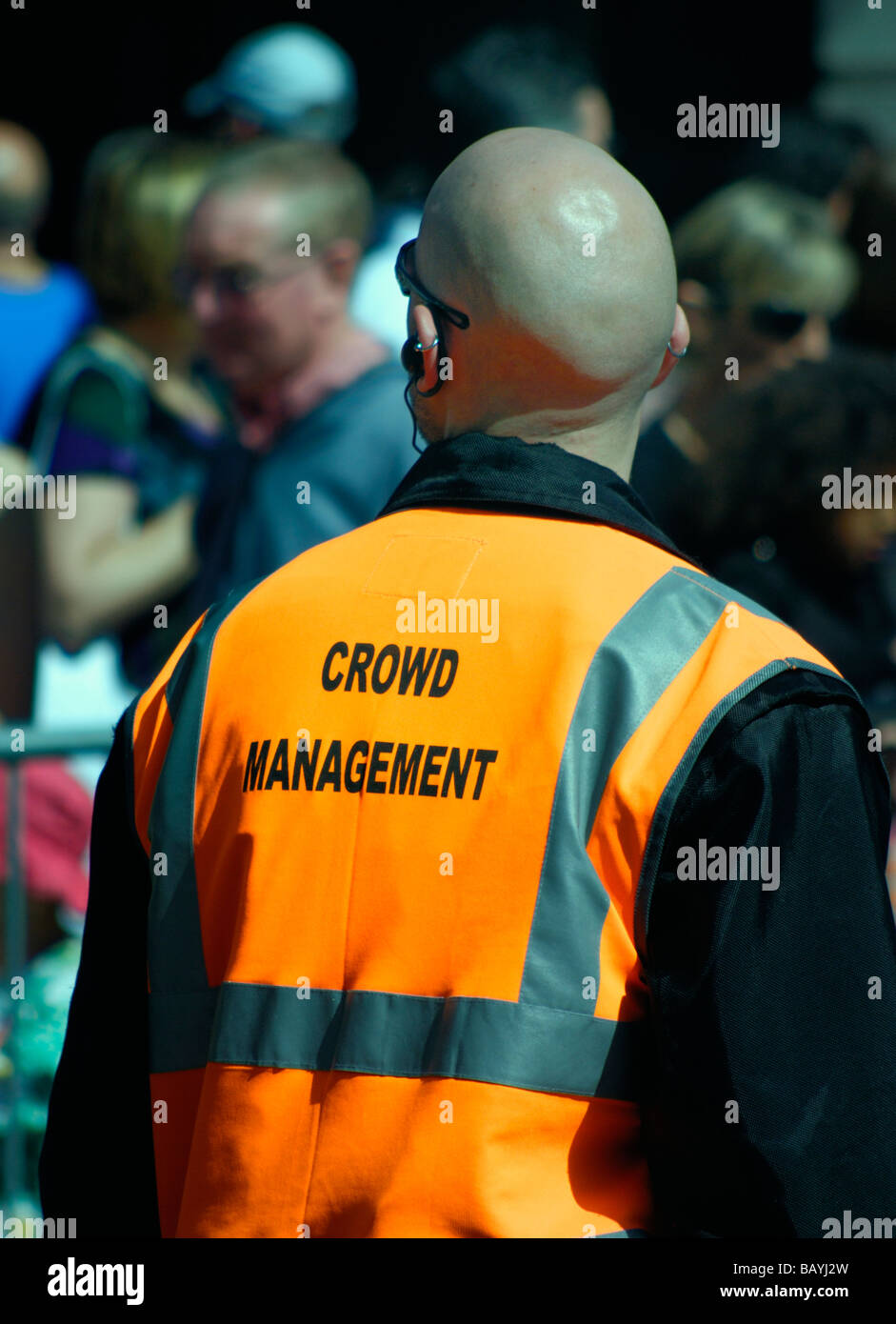 Crowd management worker with orange fluorescent jacket Stock Photo