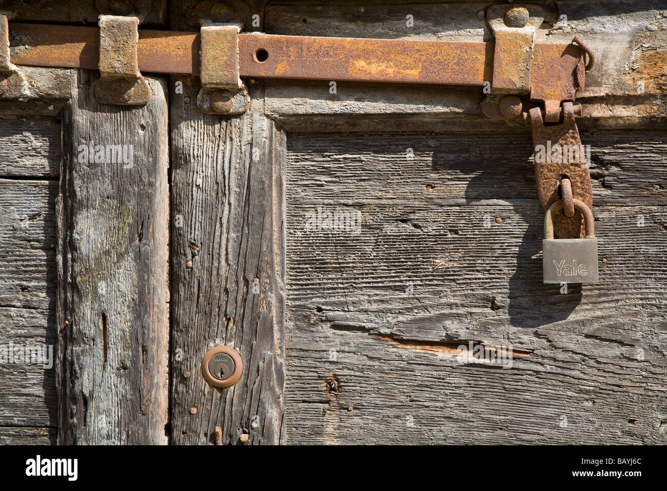 knarled wooden door detail rusty bolts locks Yale Stock Photo