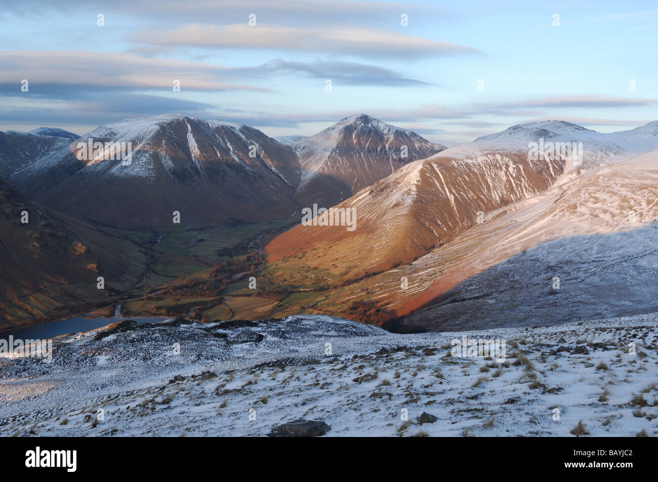 Wasdale Head surrounded by the snow covered hills of Kirk Fell Great Gable and Lingmell Stock Photo