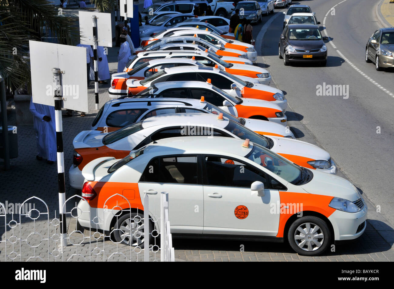Muttrah Muscat long line of parked taxi cabs beside waterfront dual carriageway Stock Photo