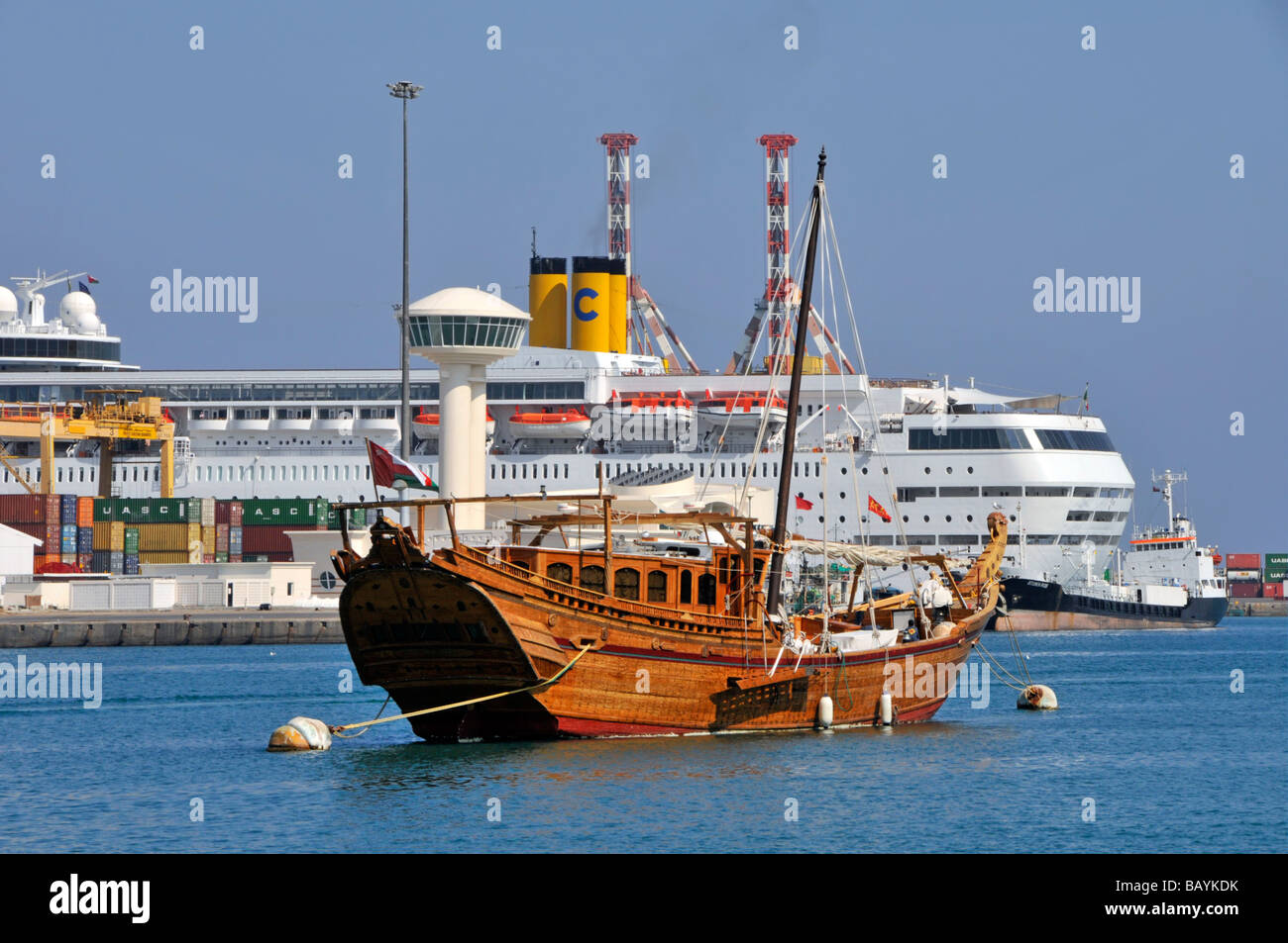 Muscat Oman Dhow moored in Muttrah harbour Costa Classica cruise ship tourism liner docked in Port Sultan Qaboos in Gulf of Oman Middle East Asia Stock Photo