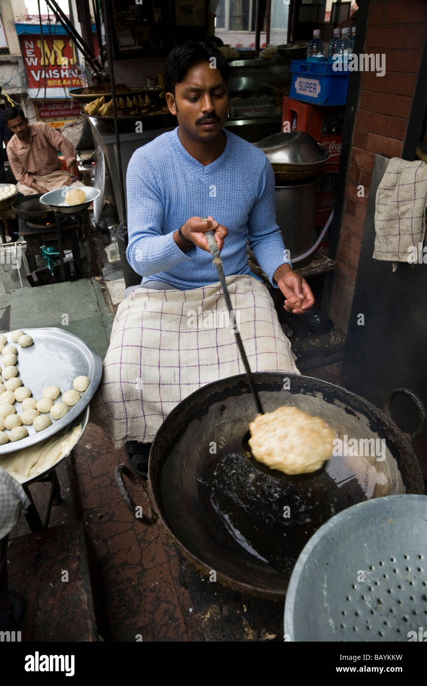 Indian man frying puri / poori bread in Shimla. Himachal Pradesh. India ...