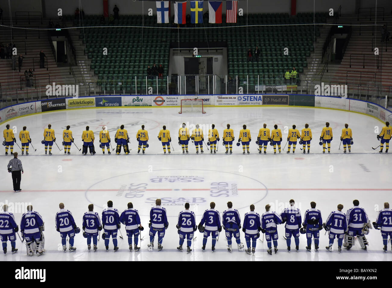 Listening to the national anthems before the game in a U18 ice-hockey tournament between Sweden and Finland. Stock Photo