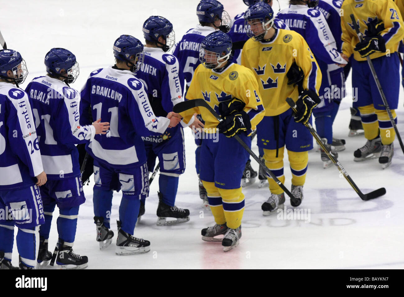 Swedish and Finnish team shaking hands after the game in a U18 ice