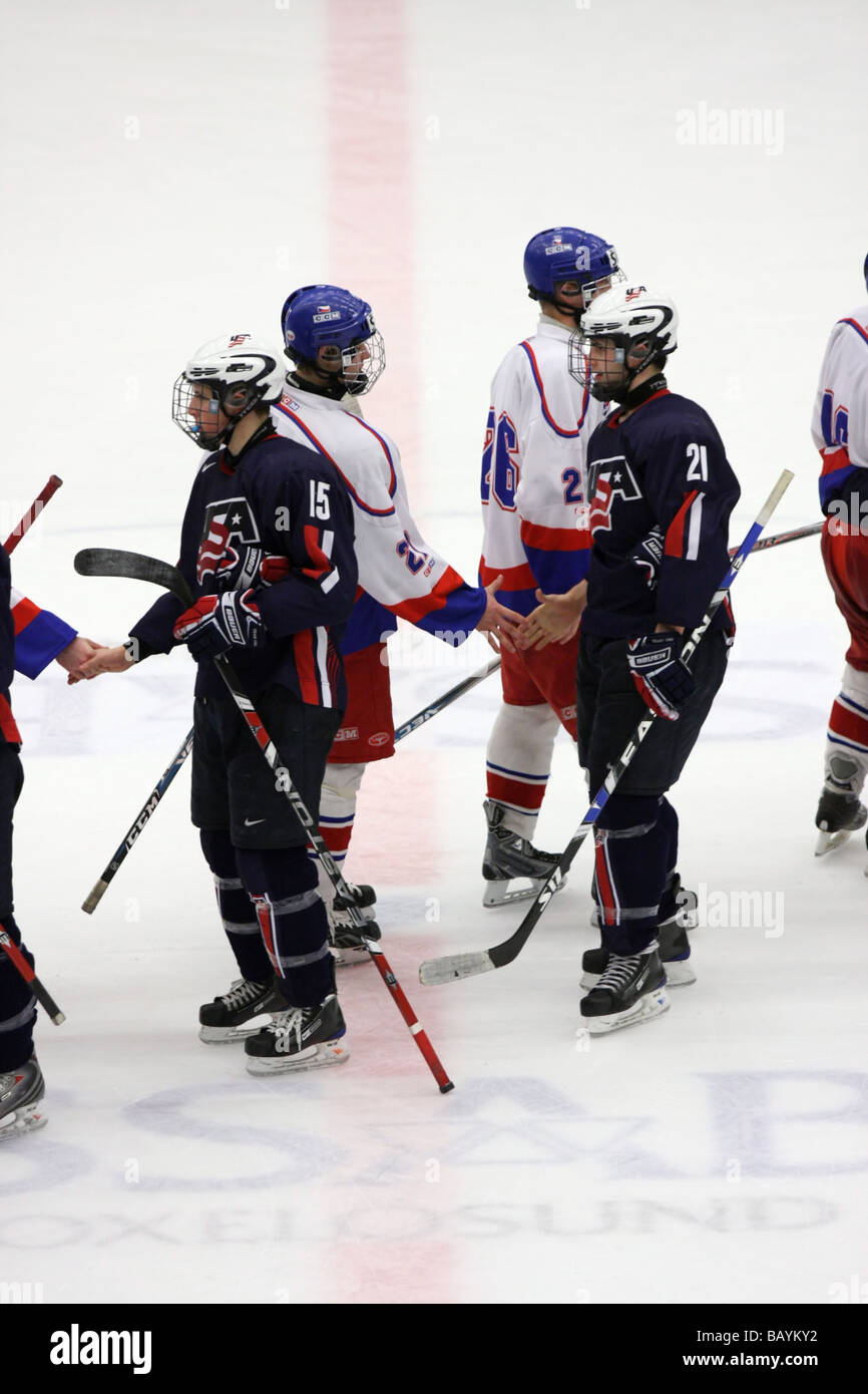 Czech and US teams shaking hands efter the game in a U18 ice-hockey tournament. Stock Photo