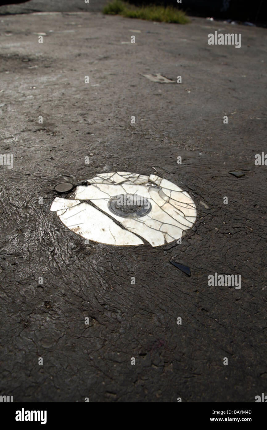 one old damaged cd compact disc disk on road surface Stock Photo