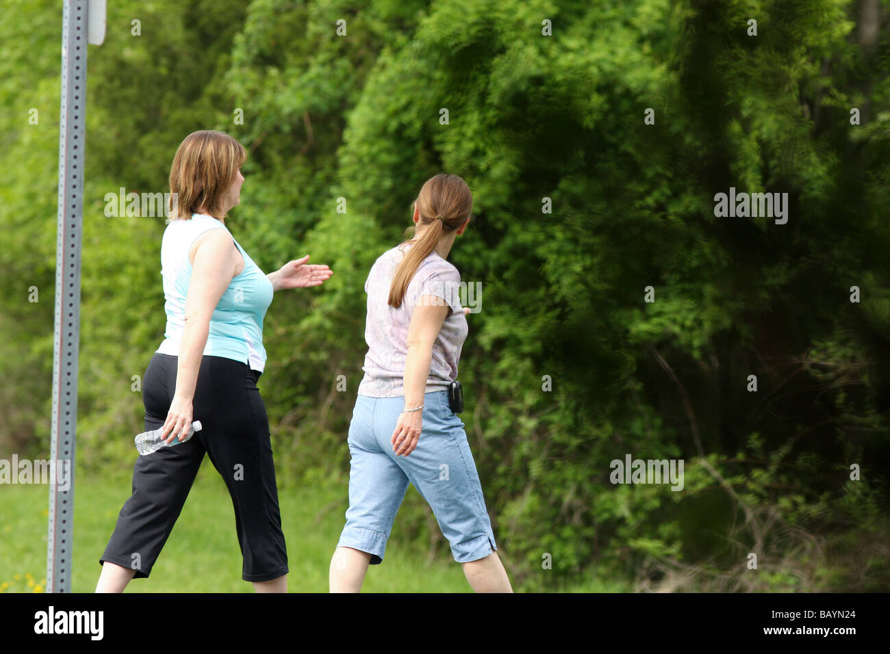 Two women walking in the park for exercise Stock Photo - Alamy