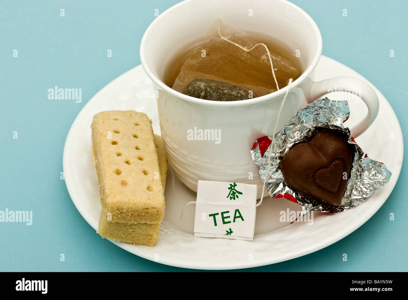 Cup of tea with shortbread biscuit and chocolate candy Stock Photo