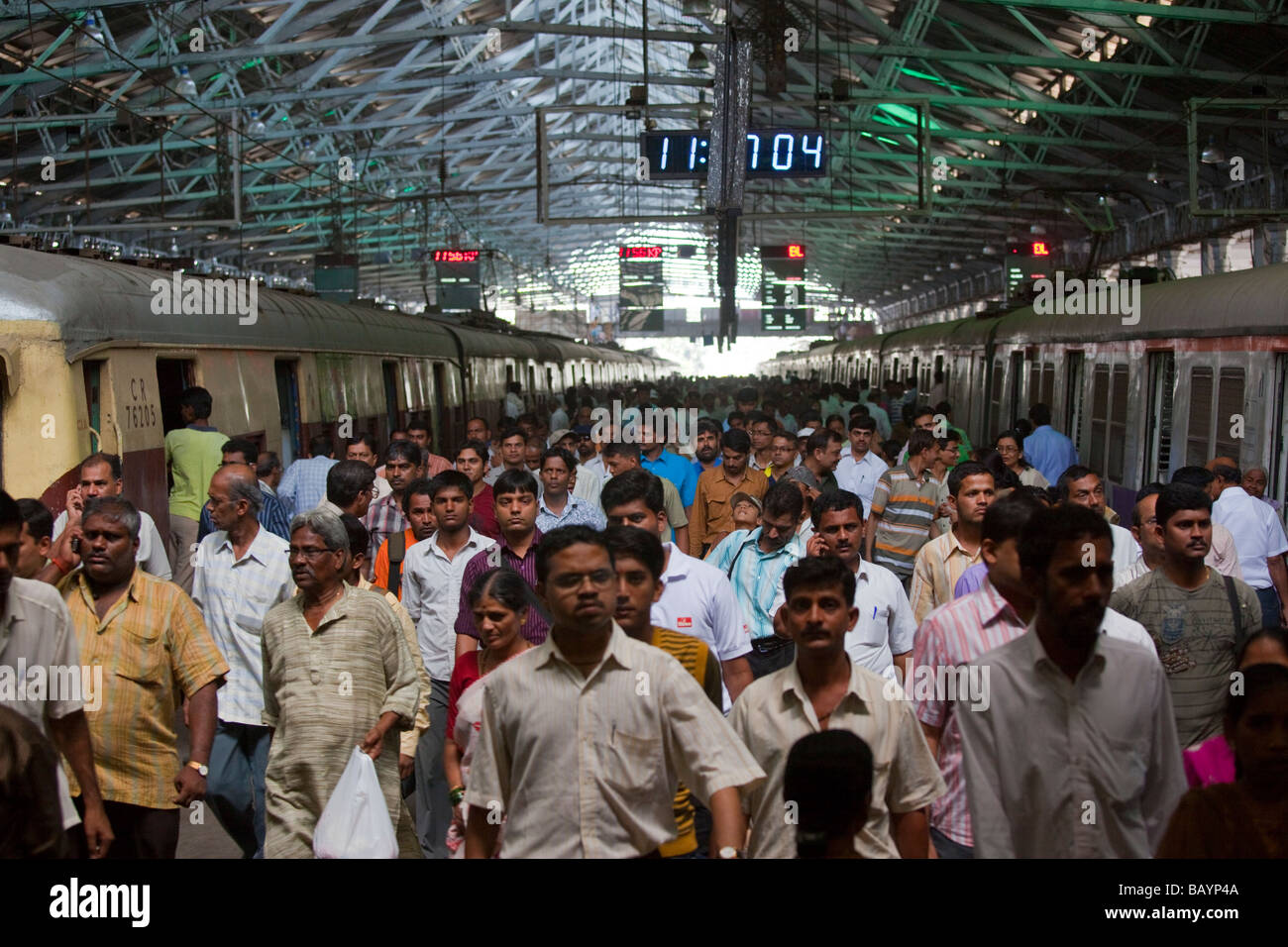 Crowded Train Platform inside Victoria Terminus Railway Station in Mumbai India Stock Photo
