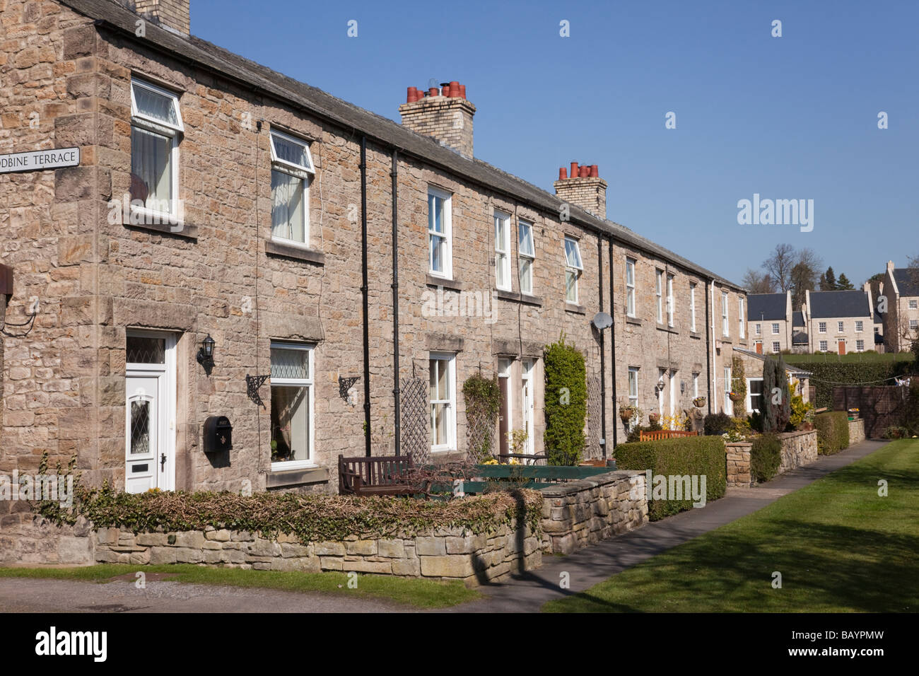 Row of terraced houses on quiet street in small historic northern town of Corbridge Northumberland England UK Britain Stock Photo