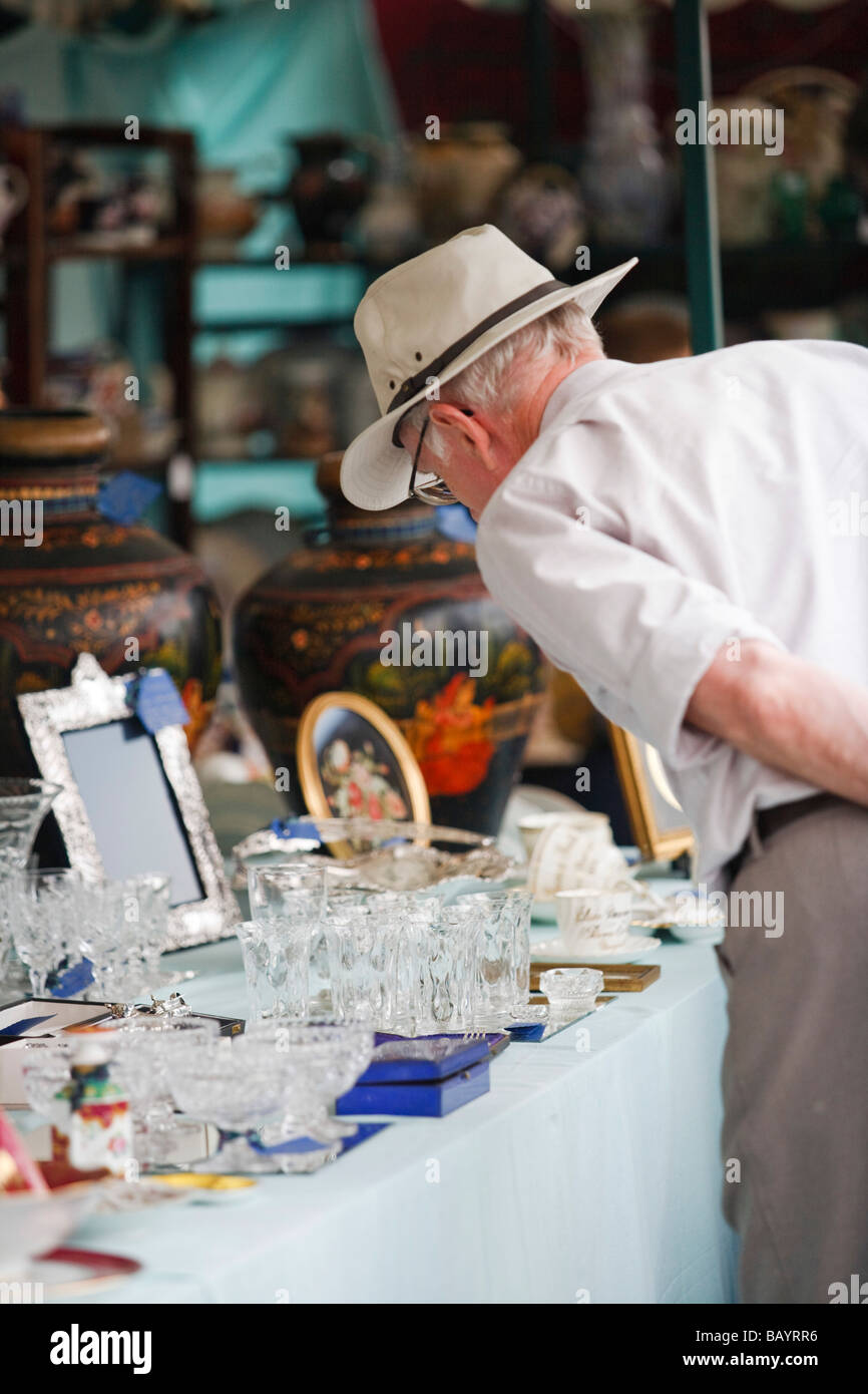 An elderly man browsing antiques at Gloucester Antiques & Collectables Fair, Gloucester, UK Stock Photo