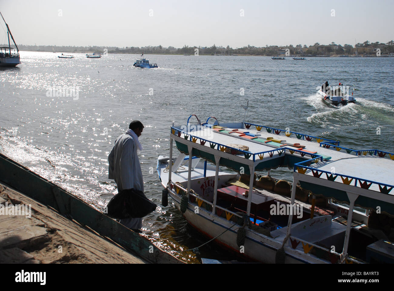 On the Nile River in Luxor, Egypt, a ferry drops off tourists Stock ...