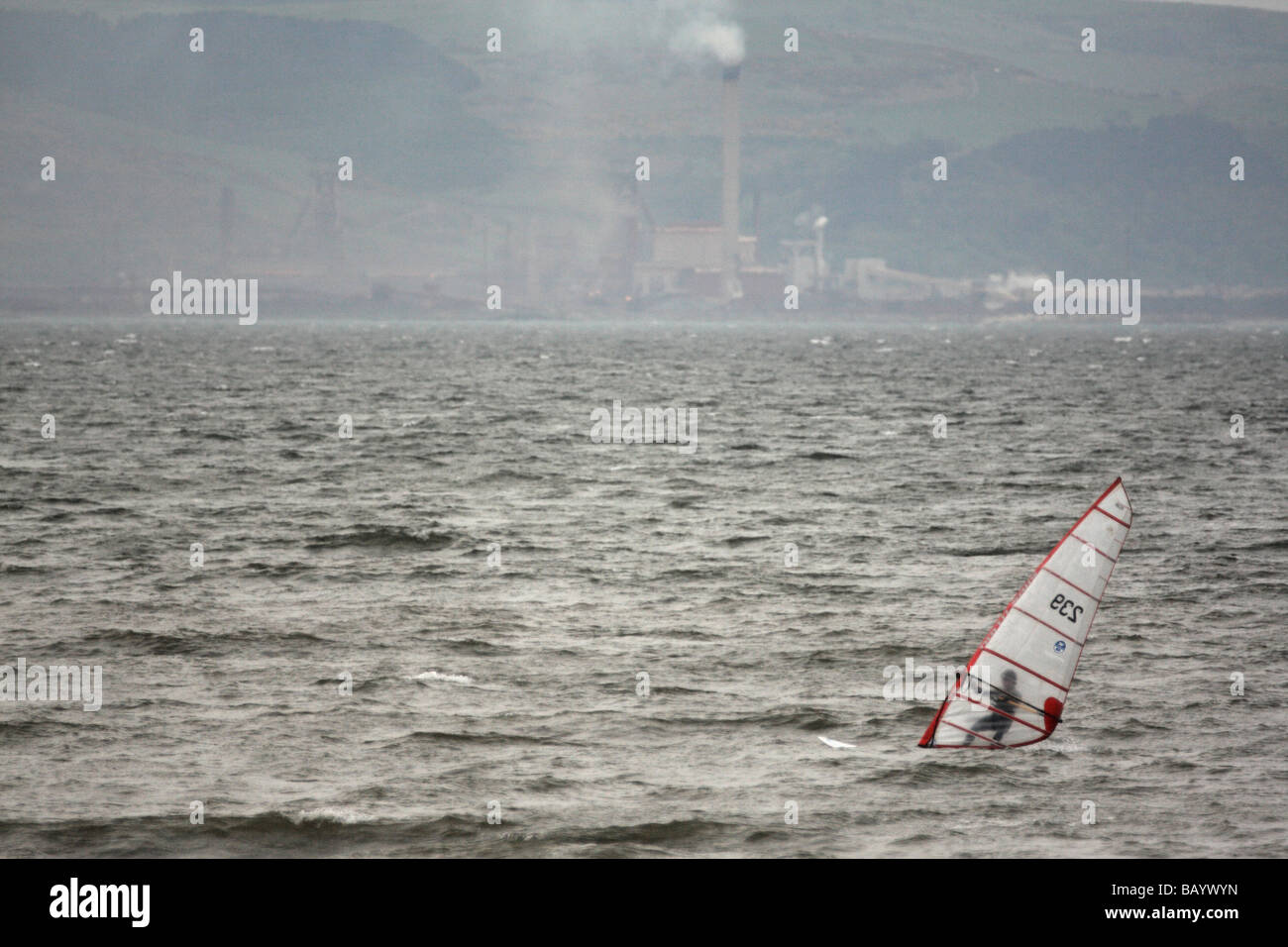 Windsurfer on Swansea Bay, with the Port Talbot power station in the background, West Glamorgan, South Wales, U.K. Stock Photo