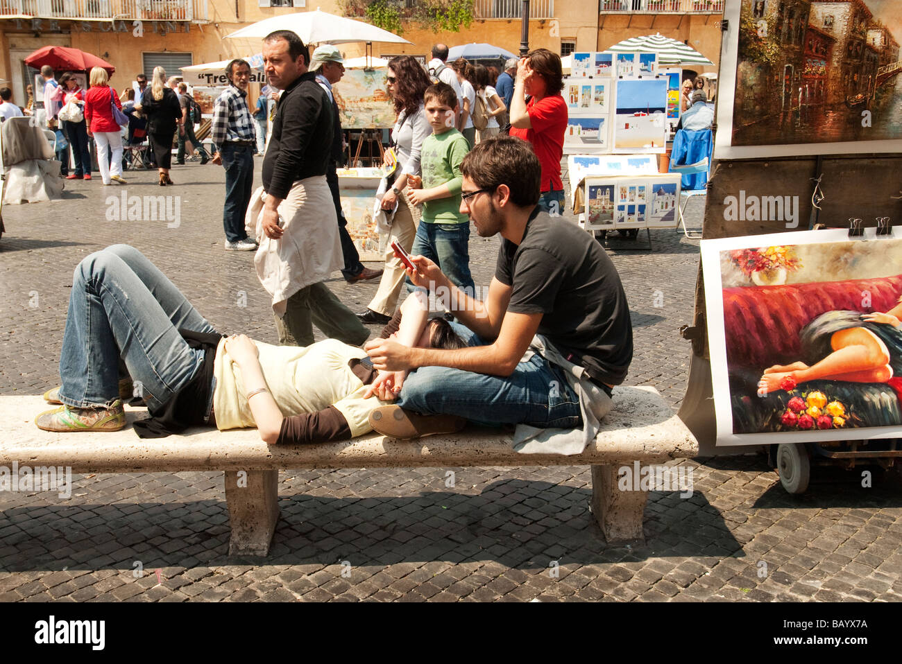 couple of tourist on a bench in the Piazza Navona Stock Photo