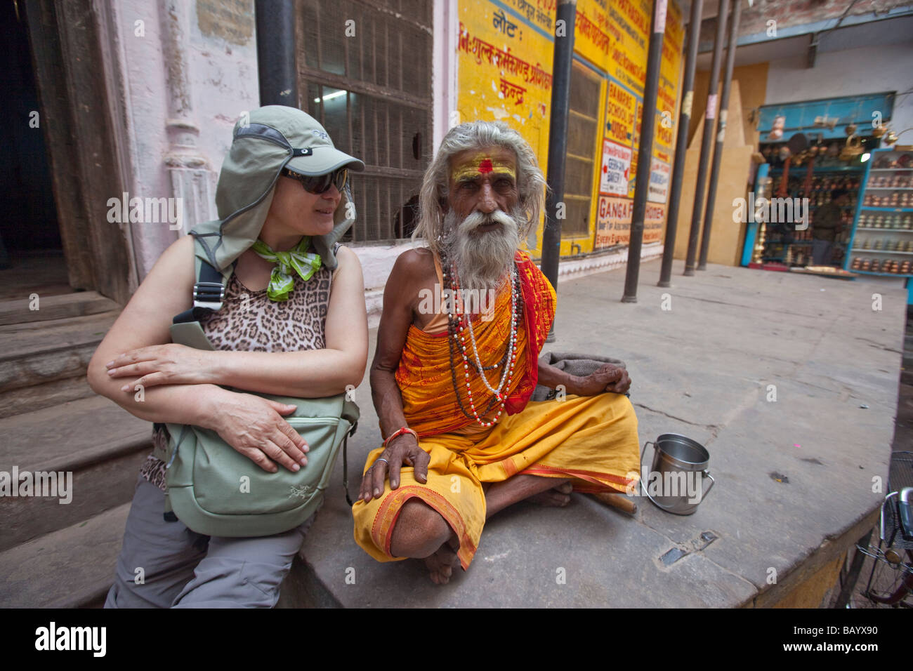South Korean Tourist and Sadhu Hindu Holy Man in Varanasi India Stock Photo