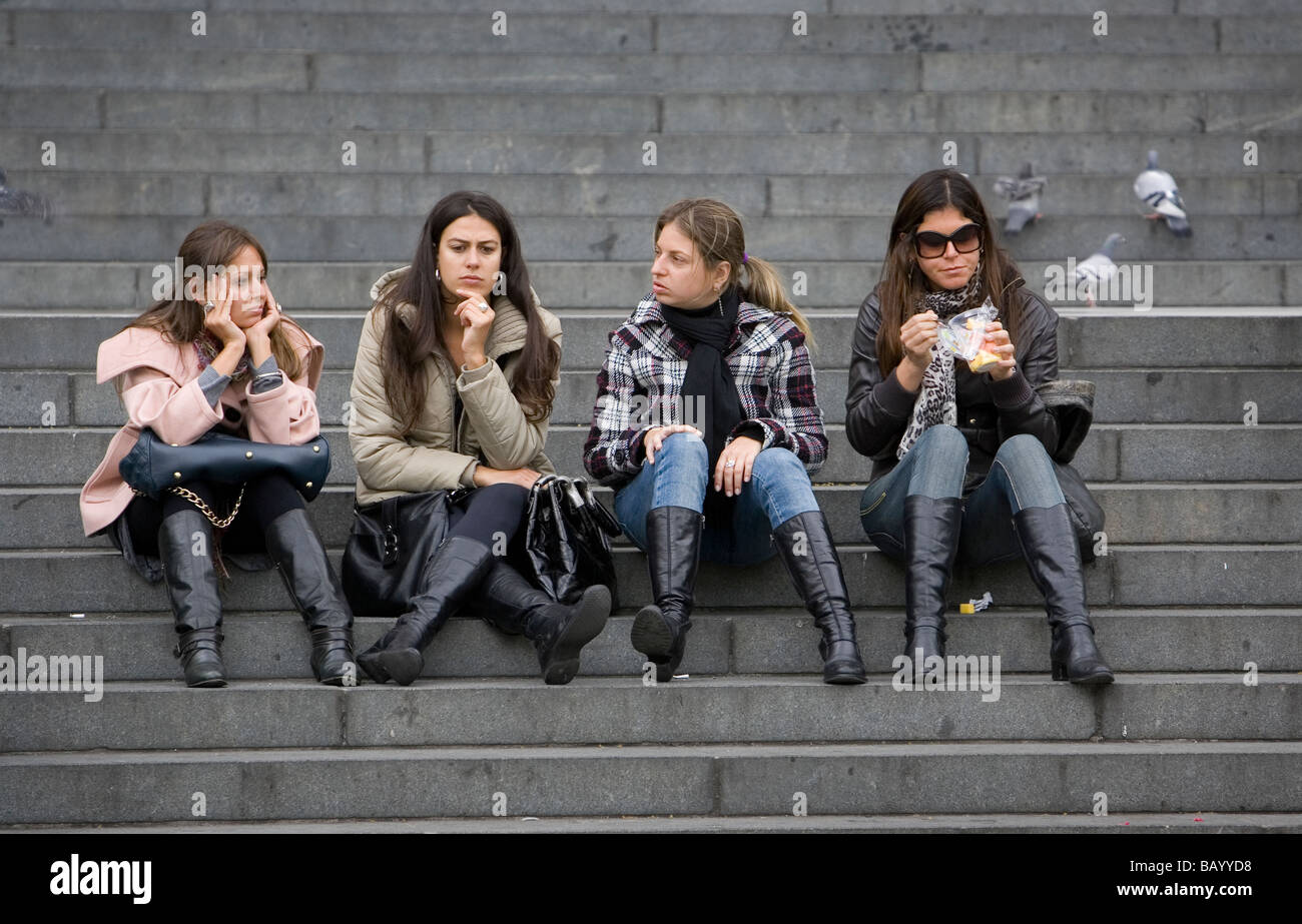 four women sitting on the stairs at St Paul's Cathedral, London, UK