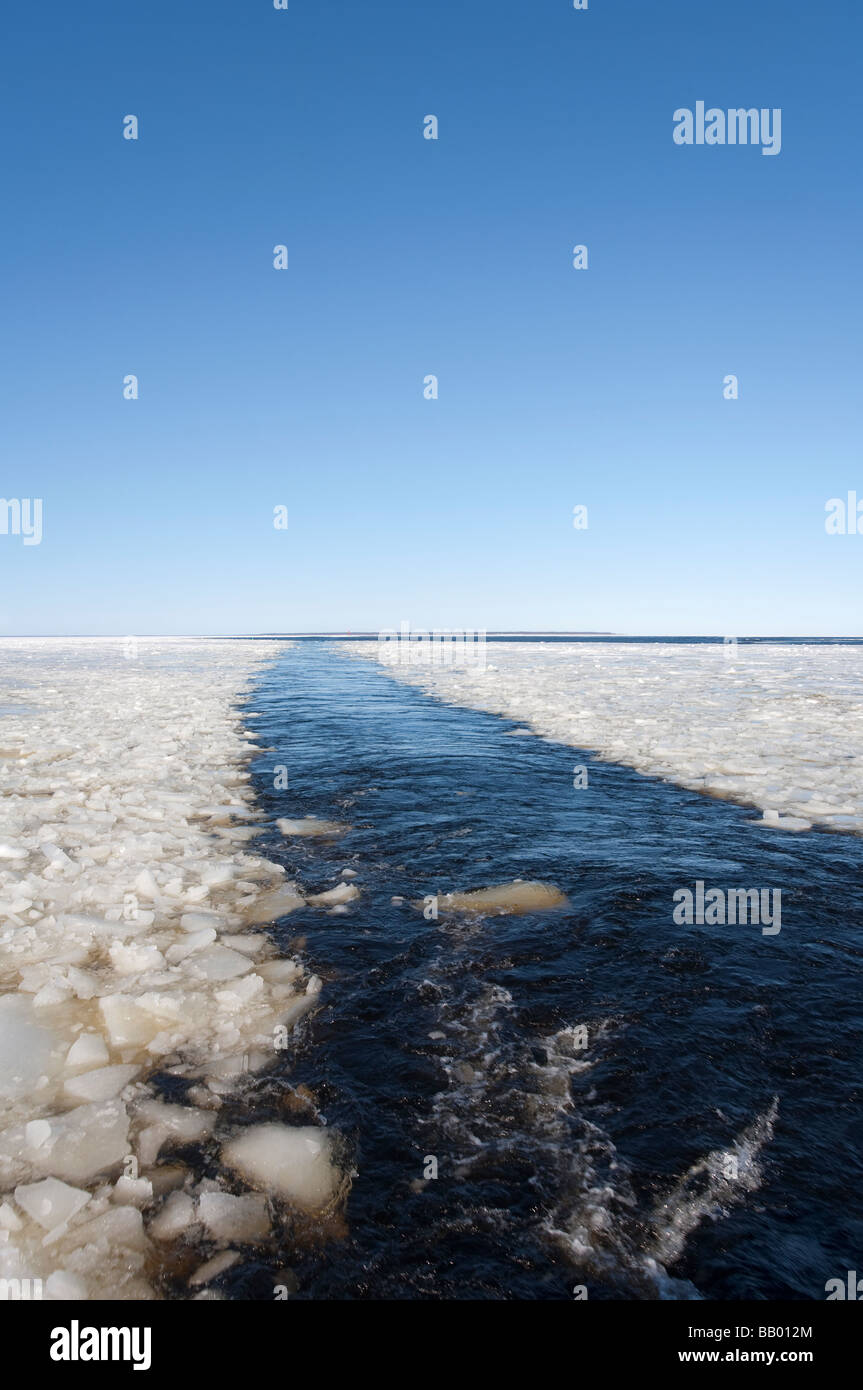 Breaking sea ice on ship's wake at Baltic Sea , Gulf of Bothnia , Hailuoto Island at the horizon , Finland Stock Photo
