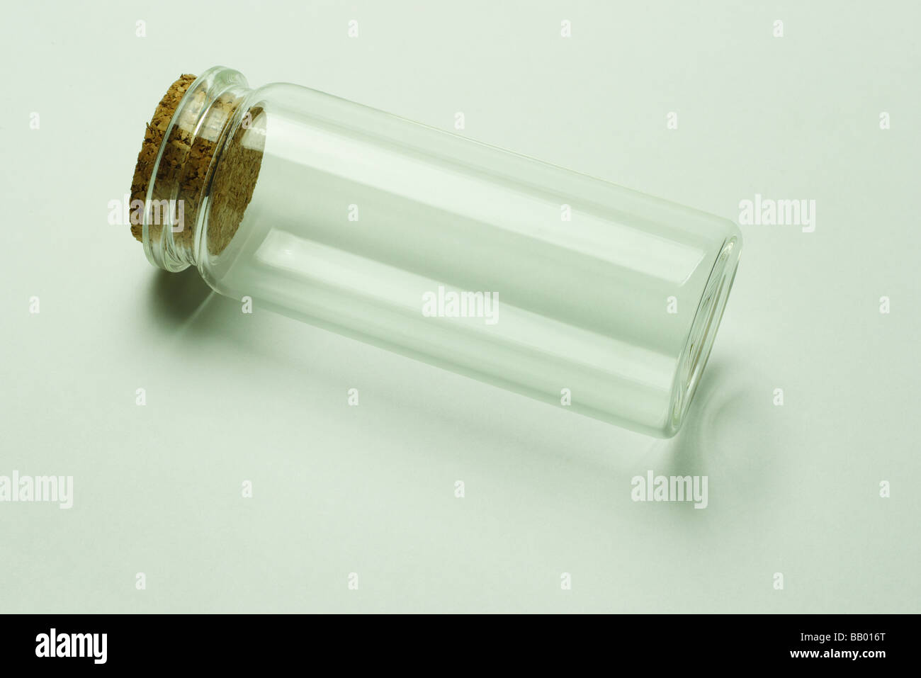 Empty glass container with cork stopper on seamless background Stock Photo