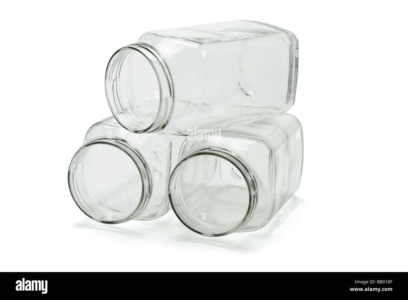 Three open glass jars stacked on white background Stock Photo
