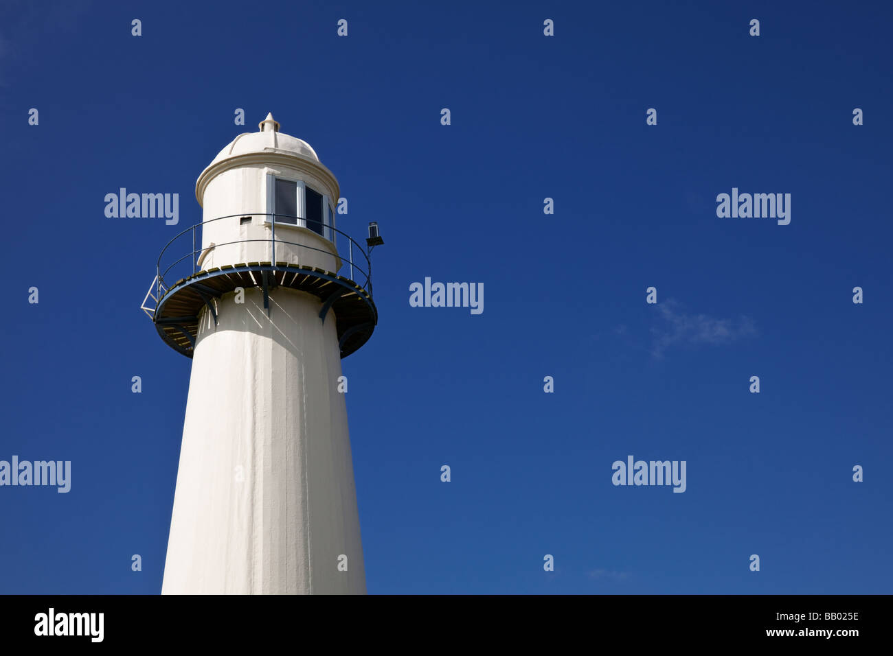 Top section housing the light on a traditional UK Lighthouse against a blue sky - with copy space Stock Photo
