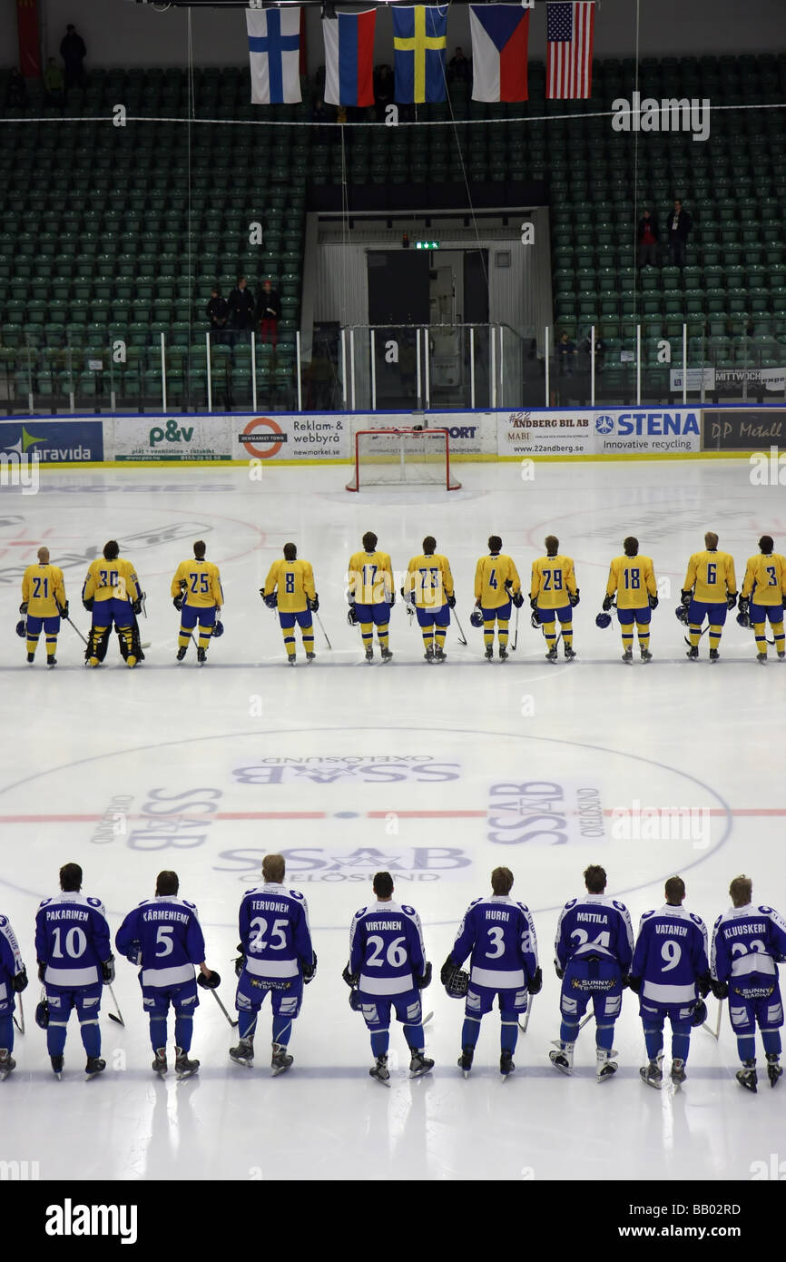 Listening to the national anthems before the game in a U18 ice-hockey tournament between Sweden and Finland. Stock Photo