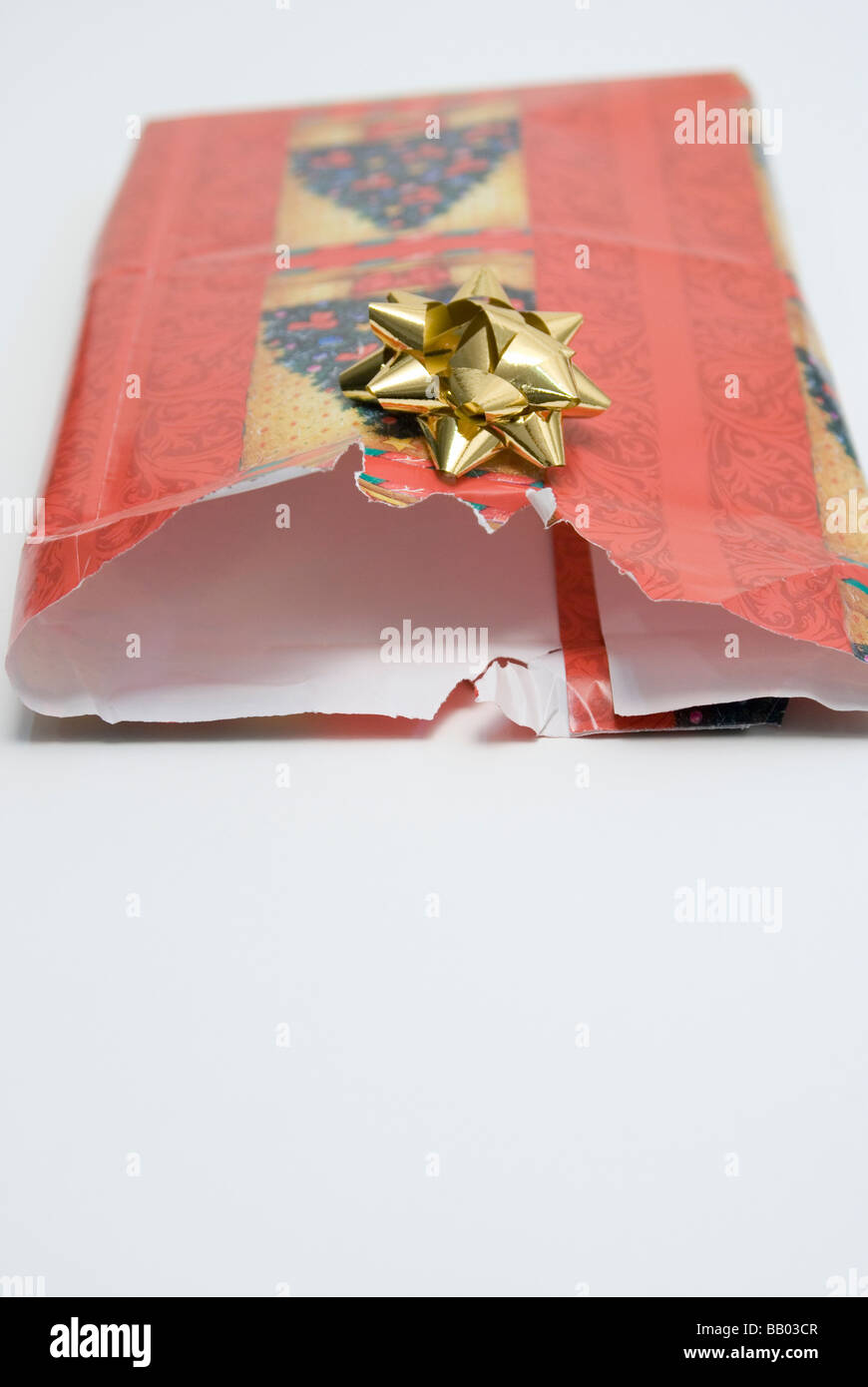 opened wrapping paper with gift bow Stock Photo