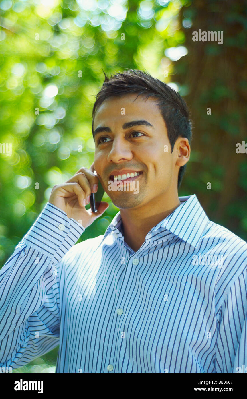 Hispanic man talking on cell phone outdoors Stock Photo