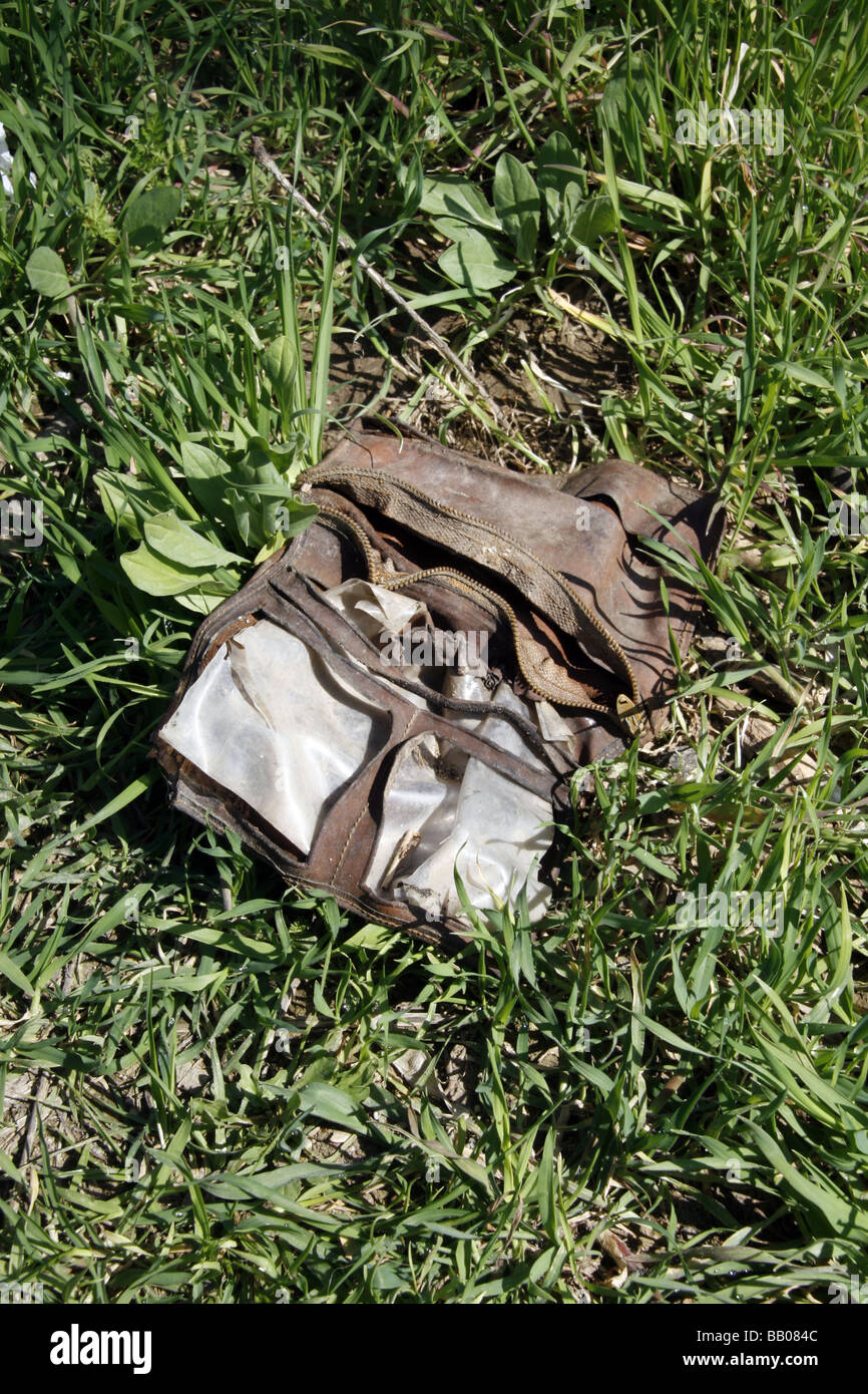 one old dirty damaged wallet left in field in country Stock Photo - Alamy